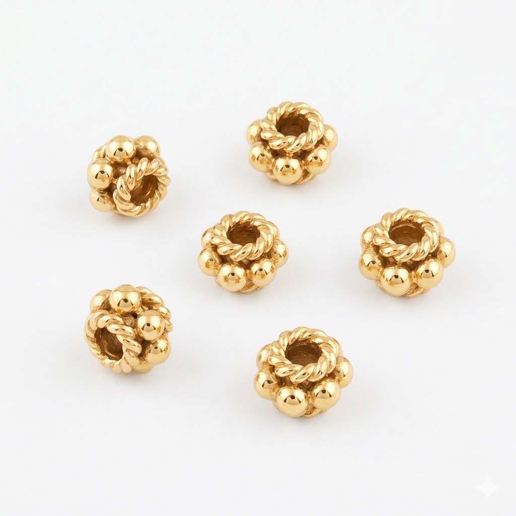 Five 24k gold-plated decorative spacer beads with intricate rope texture and polished spheres on a white background.