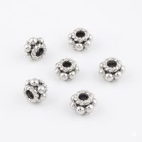Five silver plated decorative spacer beads with intricate rope texture and polished spheres on a white background